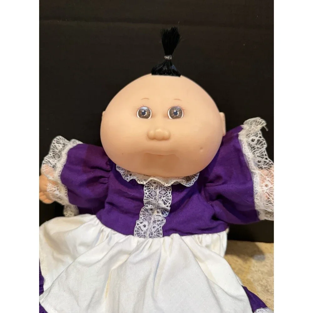 cabbage patch doll from 1990 made by mattel- purple dress
